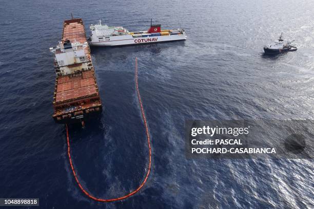 Aerial view taken from an helicopter on October 10, 2018 shows the French navy ocean tug L'Abeille Flandre and two cargo ships - the Tunisian...