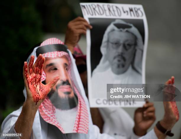 Demonstrator dressed as Saudi Arabian Crown Prince Mohammed bin Salman with blood on his hands protests outside the Saudi Embassy in Washington, DC,...