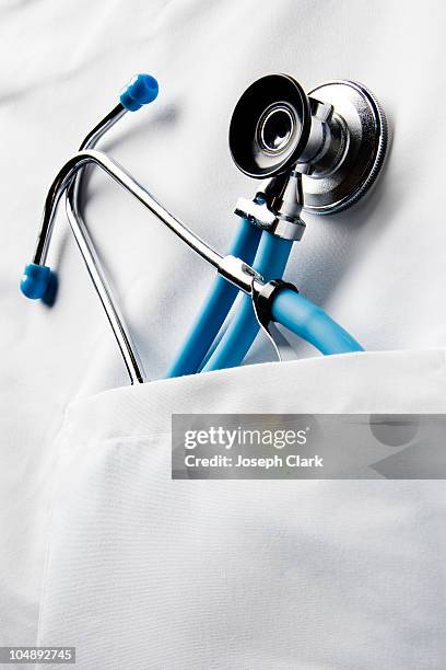 stethoscope in doctor's pocket - stethoskop stock-fotos und bilder