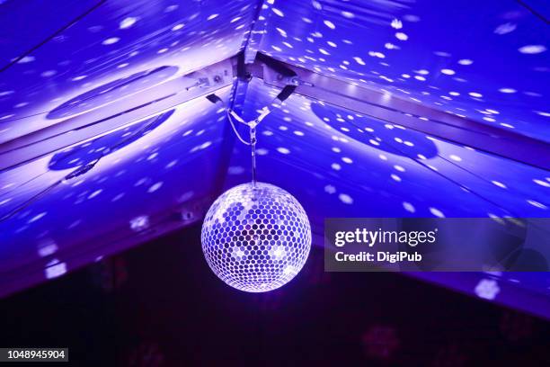 disco ball hanging in tent at music event - disco ball foto e immagini stock