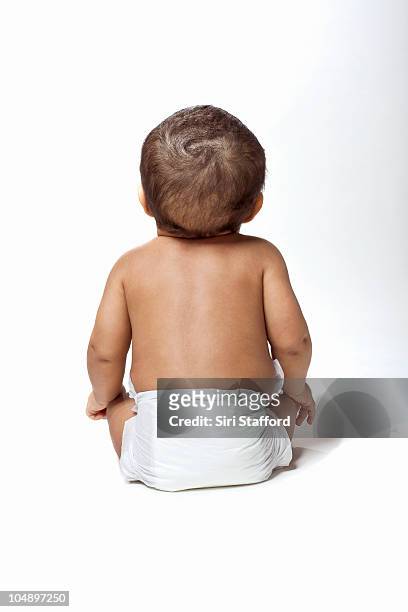 young baby looking up with diaper on, backview - baby white background foto e immagini stock