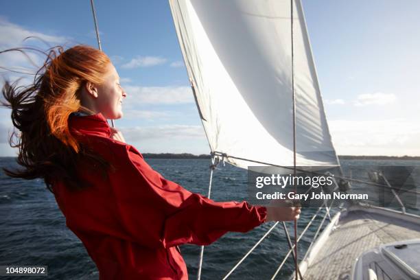 sailing yacht in windy condition summer - people in air stock-fotos und bilder