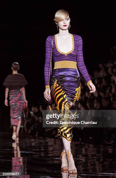 Model walks the runway during the Louis Vuitton Ready to Wear Spring/Summer 2011 show during Paris Fashion Week at Cour Carree du Louvre on October...