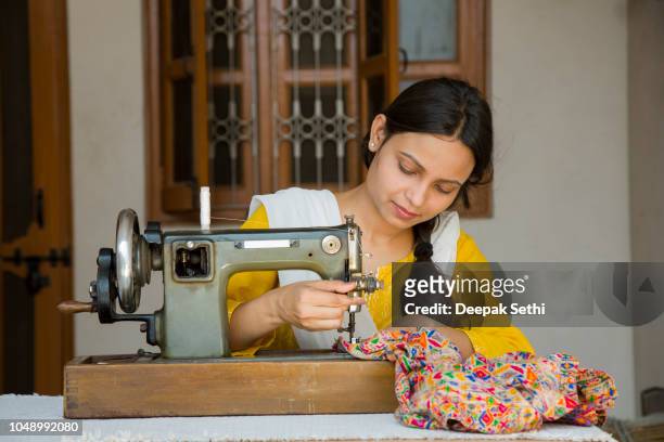 indian young girl sewing - stock image - sewing machine stock pictures, royalty-free photos & images