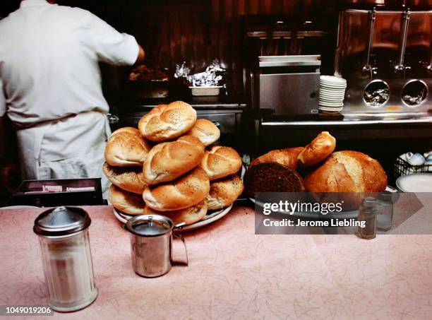 View of piles of rolls and rye bread heaped on plates on a unidentified restaurant's lunch counter in Brooklyn's Brighton Beach neighborhood, New...