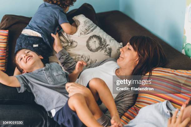 mother and sons struggling - family with three children stock pictures, royalty-free photos & images