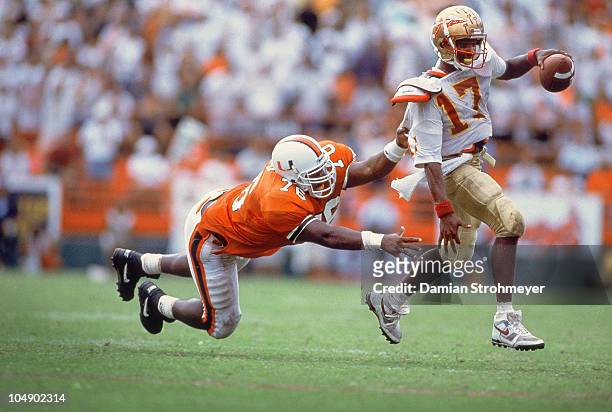 Florida State QB Charlie Ward in action, under pressure vs Miami Warren Sapp . Miami, FL 10/3/1992 CREDIT: Damian Strohmeyer