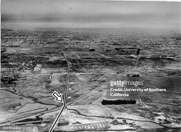 Aerial photograph showing intersection of Wilshire and San Vicente boulevards. '1922 / Sunday pictorial review / Three decades ago there was little...