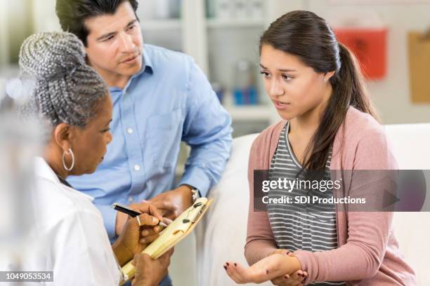 teenage girl describes symptoms to doctor - emergency medicine stock pictures, royalty-free photos & images