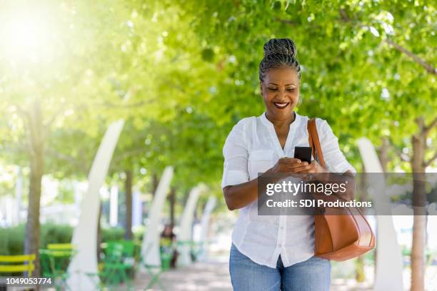 Photo Walk Using Phone Woman Uses Smartphone While Walking In Park High-Res Stock Photo ...