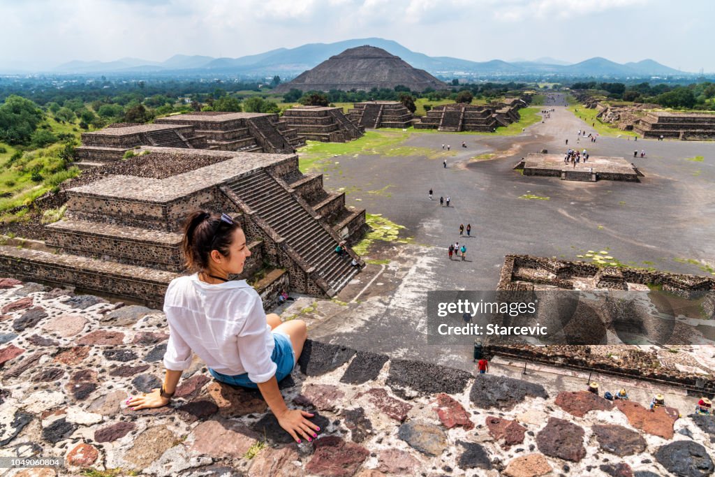 Tourism in Mexico - young adult tourist at ancient pyramids