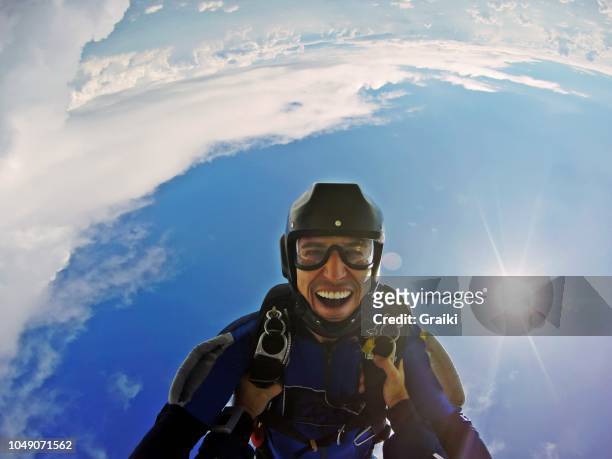 skydiver having fun in free fall. point of view jump - fallschirmsprung stock-fotos und bilder
