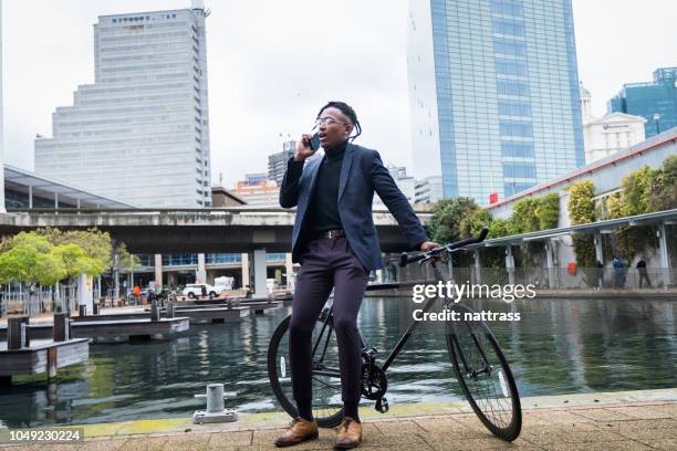 young african entrepreneur on his mobile phone - cape town buildings stock pictures, royalty-free photos & images