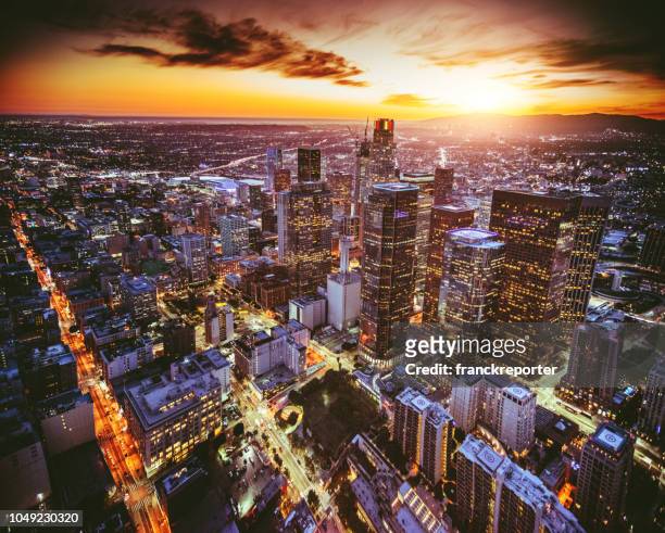 aerial view of the los angeles downtown at dusk - downtown los angeles aerial stock pictures, royalty-free photos & images