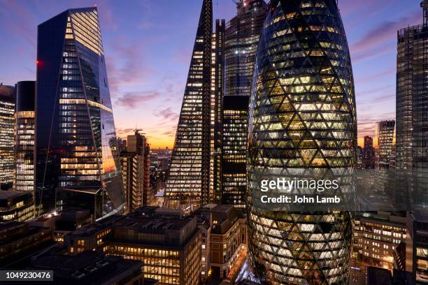 city of london financial district at dusk - lloyds of london stock pictures, royalty-free photos & images