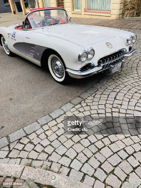 chevrolet corvette c1 on a cobblestone road - vintage car racing stock pictures, royalty-free photos & images