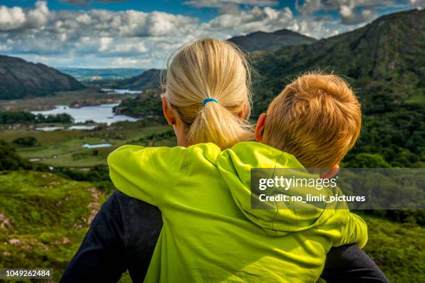 woman and boy looking over wide irish landscape - 2 dramatic landscape stock pictures, royalty-free photos & images