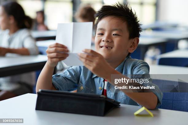 Boy Opening Note Kids Passing Notes Photos and Premium High Res Pictures - Getty Images