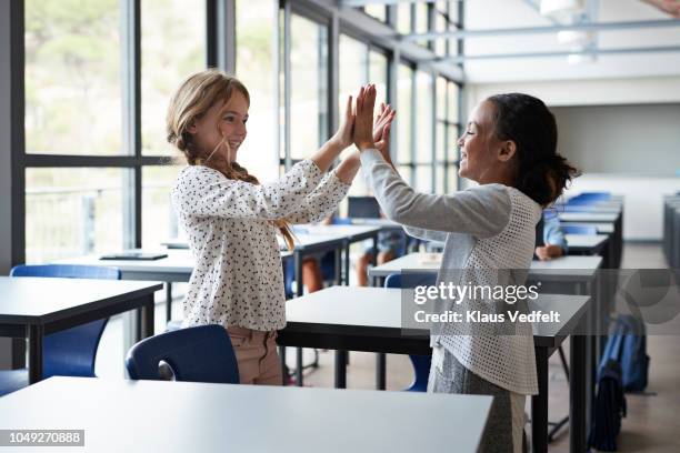 girlfriends doing clapping game in classroom - clapping game stock pictures, royalty-free photos & images