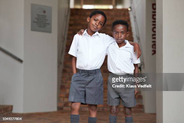 Portrait of two cool school boys in uniforms