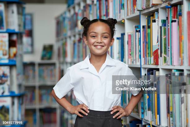 portrait of cute schoolgirl at the library - 8歳から9歳 ストックフォトと画像