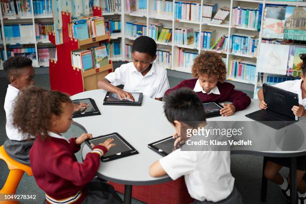 school children working on digital tablets at the library - open day 7 stockfoto's en -beelden