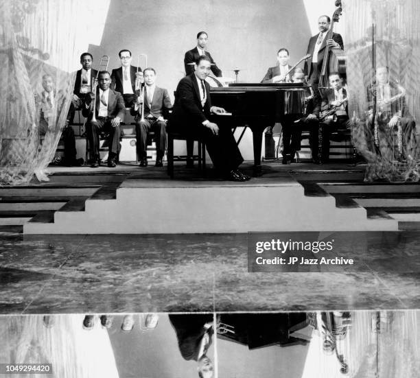 American jazz pianist composer and bandleader Duke Ellington Orchestra 1929. Behind from left Tricky Joe Nanton, Juan Tizol Sonny Greer Fred Cray...