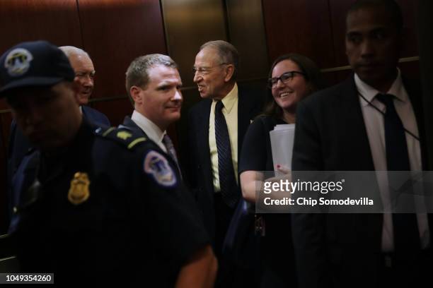 Senate Judiciary Committee Chairman Chuck Grassley is surrounded by staff and security as he heads for a secure meeting space inside the U.S. Capitol...