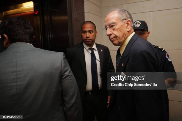 Senate Judiciary Committee Chairman Charles Grassley is surrounded by staff and security as he heads for a secure meeting space inside the U.S....