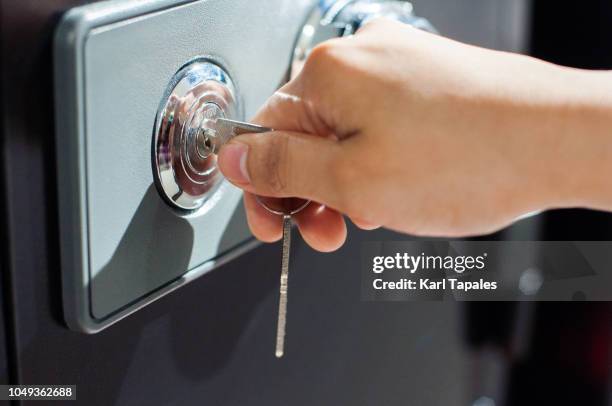 close up of human hand opening a safe deposit box - safe deposit box stock pictures, royalty-free photos & images