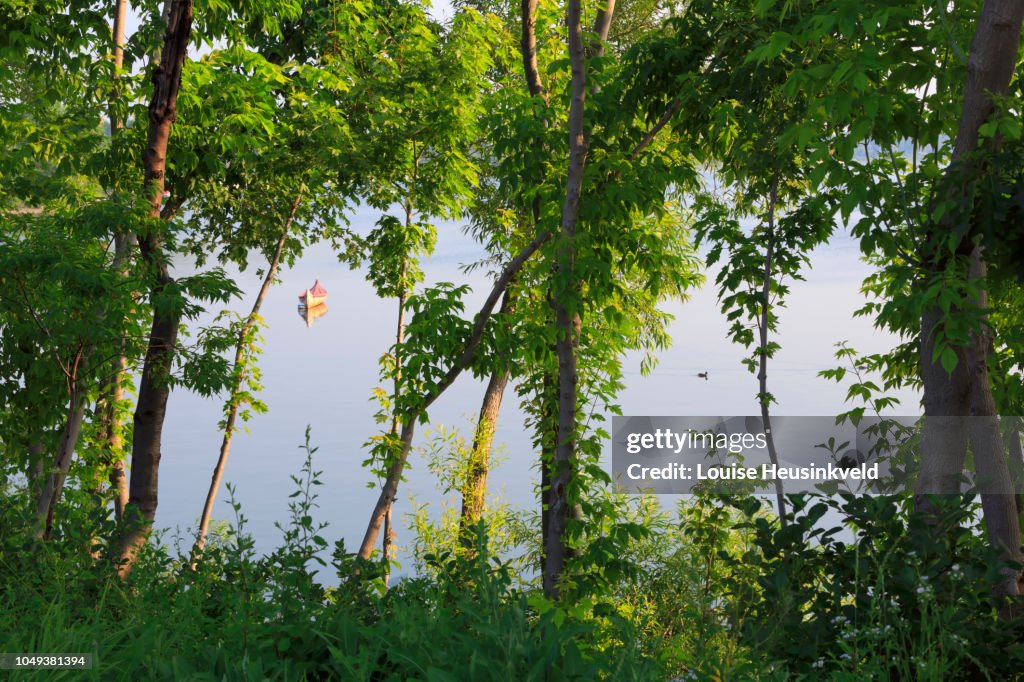 Traditional birch bark canoe on a mooring ball in Chambly Basin, Quebec