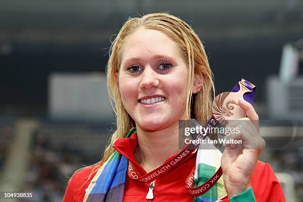 Jemma Lowe of Wales poses with the bronze medal during the medal ceremony for the Women's 100m Butterfly Final at the Dr. S.P. Mukherjee Aquatics...