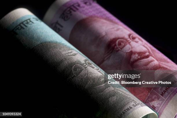 the portrait of mahatma gandhi is displayed on an indian 50 rupee, left, and 2000 rupee banknotes - indian currency stock pictures, royalty-free photos & images