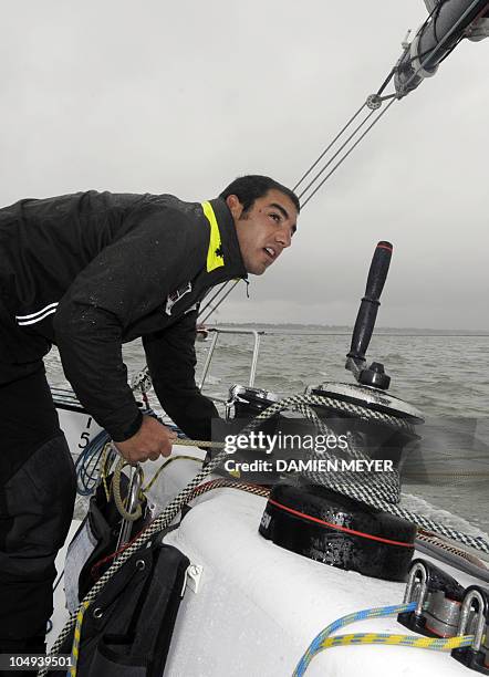 French skipper Damien Seguin sails on his "Des pieds et des mains" monohull on October 4, 2010 off the coast of Saint Nazaire western France during a...