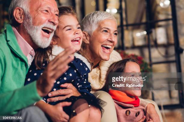 happy grandparents with grandchildren - multi generation family christmas stock pictures, royalty-free photos & images