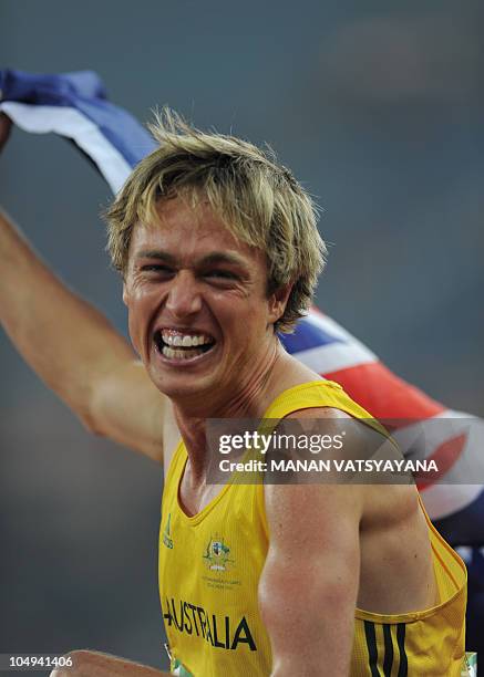 Australia's Simon Patmore celebrates winning gold in the parasport men 100m final of the Track and Field competition of the XIX Commonwealth games on...