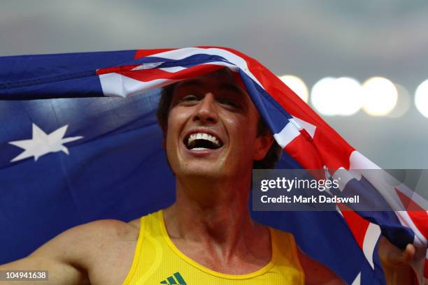 Simon Patmore of Australia celebrates after winning gold in the men's T46 100 metres final during day four of the Delhi 2010 Commonwealth Games at...