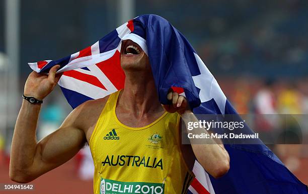 Simon Patmore of Australia celebrates after winning gold in the men's T46 100 metres final during day four of the Delhi 2010 Commonwealth Games at...