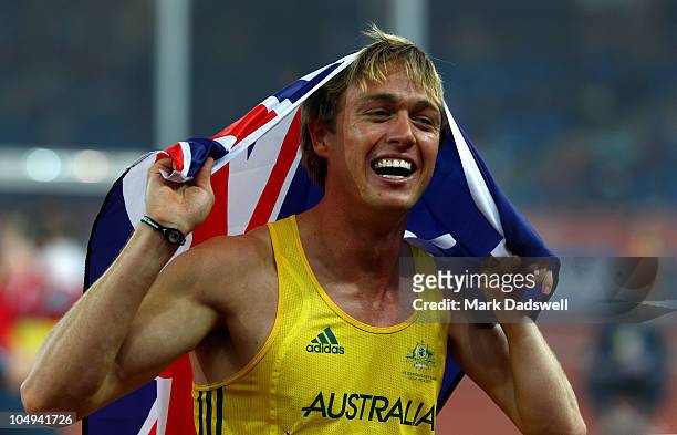 Simon Patmore of Australia celebrates after winning gold in the men's T46 100 metres final during day four of the Delhi 2010 Commonwealth Games at...