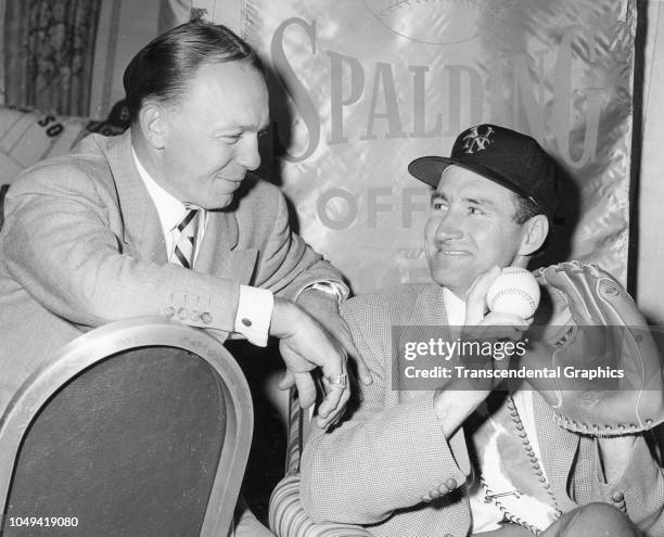 View of American baseball players Eddie Stanky and Alvin Dark as they smile at one another during a banquet, New York, New York, 1954.