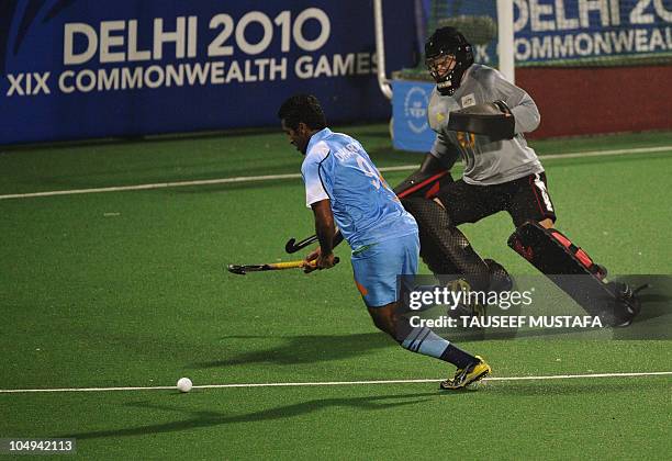 Dharamvir Singh of India attempts a goal against Australia during their field hockey match at the Major Dhyan Chand National Stadium during the XIX...