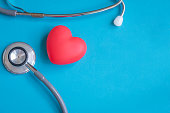 Health care check up with red heart and Stethoscope on blue background. Health care background and copy space used for add message or graphic montage.
