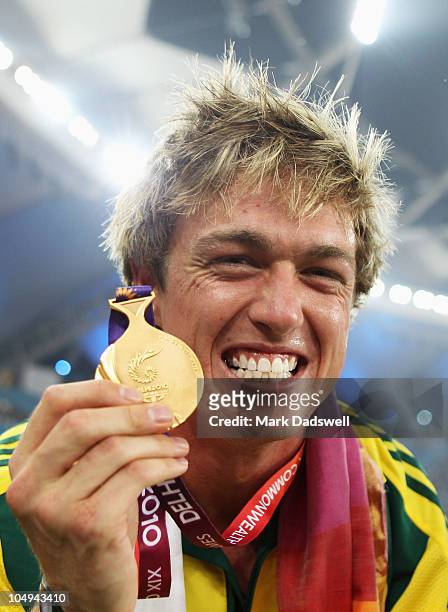 Simon Patmore of Australia celebrates with his gold medal after winning the men's T46 100 metres final during day four of the Delhi 2010 Commonwealth...