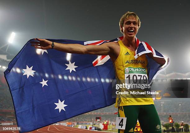 Simon Patmore of Australia celebrates after winning gold in the men's T46 100 metres final during day four of the Delhi 2010 Commonwealth Games at...