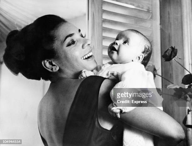 Singer Shirley Bassey with her 10 week old daughter Samantha at home in Belgravia, London on January 24, 1964.