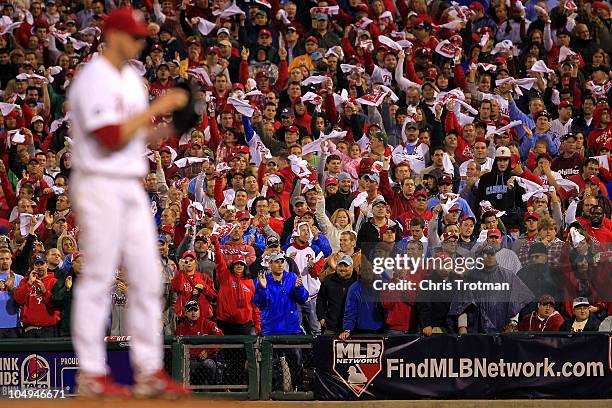 Fans cheer on pitcher Roy Halladay of the Philadelphia Phillies as he prepares to pitch during his no-hitter in Game 1 of the NLDS against the...