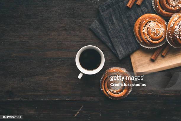 traditional swedish cinnamon bun on a wooden table - sweet bun stock pictures, royalty-free photos & images