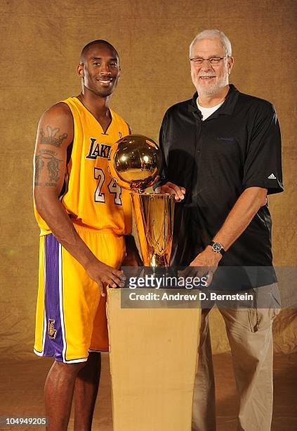 Kobe Bryant and Head Coach Phil Jackson of the Los Angeles Lakers pose with the Larry O'Brien Trophy during NBA Media Day at Toyota Sports Center on...