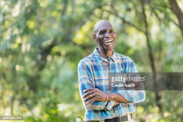 senior african-american man enjoying the outdoors - black man plaid shirt stock pictures, royalty-free photos & images