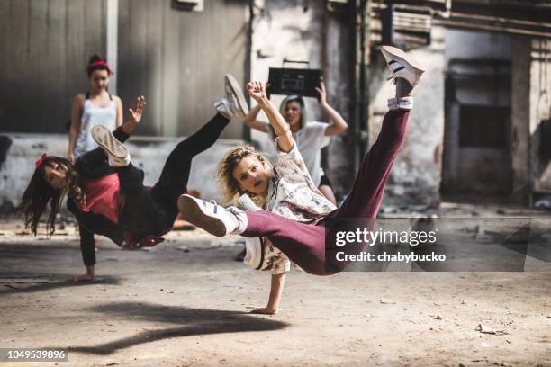 synchronized break dancers dancing together - breakdancing stock pictures, royalty-free photos & images